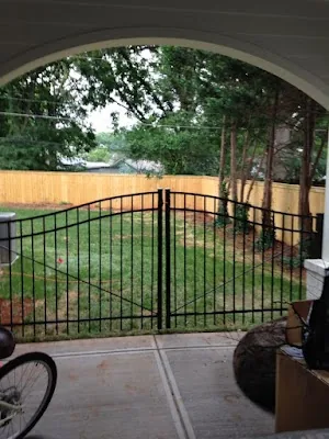 Black aluminum double gate into a fenced backyard — Timber Fencing, Monroe, NC