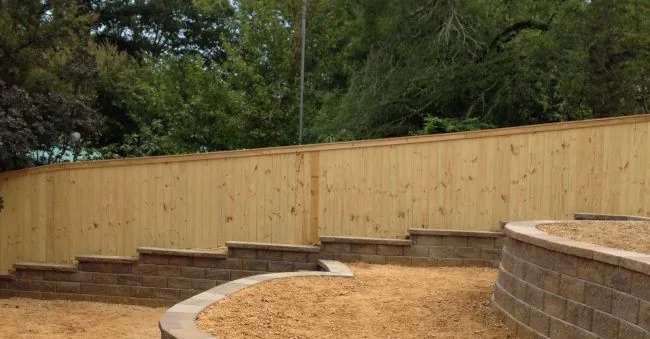 Wood privacy fence above a block retaining wall — Timber Fencing, Monroe, NC